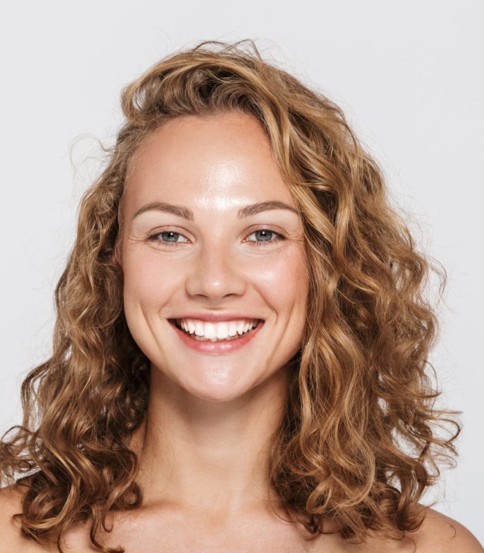 Image of happy half-naked woman smiling and looking at camera isolated over white background